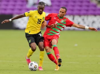 Jamaica forward BLAIR TURGOTT (15) competes for the ball against Suriname defender DAMIL DANKERLUI (2) during the 2021 Concacaf Gold Cup Jamaica vs Suriname soccer match at Exploria Stadium in Orlando, Fl on July 12, 2021.