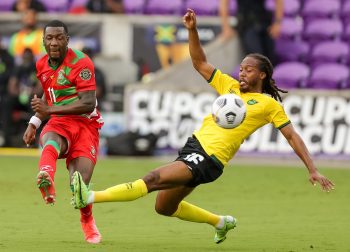 Suriname forward SHERALDO BECKER (11) makes a pass  while Jamaica midfielder DANIEL JOHNSON (16) tries to block during the 2021 Concacaf Gold Cup Jamaica vs Suriname soccer match at Exploria Stadium in Orlando, Fl on July 12, 2021.
