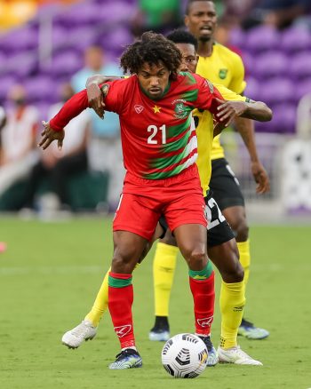 Suriname defender ALBERT NIBTE (12) competes for the ball during the 2021 Concacaf Gold Cup Jamaica vs Suriname soccer match at Exploria Stadium in Orlando, Fl on July 12, 2021.