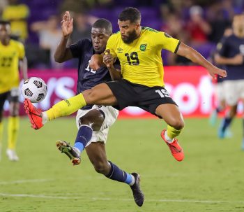 Jamaica defender ADRIAN MARIAPPA (19) makes a flying kick against Costa Rica forward JOEL CAMPBELL (12) during the 2021 Concacaf Gold Cup Costa Rica vs Jamaica soccer match at Exploria Stadium in Orlando, Fl on July 20, 2021.