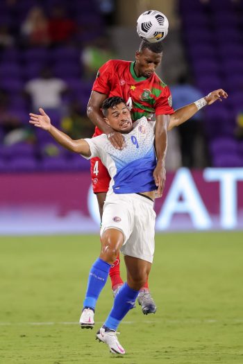 Suriname midfielder DION MALONE (4) gets a header against Costa Rica forward ARIEL RODRIGUEZ (9) during the 2021 Concacaf Gold Cup Suriname vs Costa Rica soccer match at Exploria Stadium in Orlando, Fl on July 16, 2021.