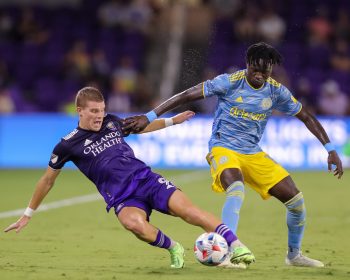 Orlando City forward CHRIS MUELLER (9) competes for the ball against Philadelphia Union defender OLIVIER MBAIZO (15) during the Orlando City vs Philadelphia Union  match at Exploria Stadium in Orlando, Fl on July 22, 2021.