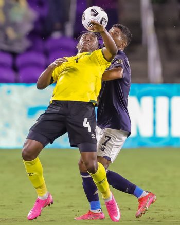 Jamaica defender AMARII BELL (4) gets a header against Costa Rica forward JOHAN VENEGAS (7) during the 2021 Concacaf Gold Cup Costa Rica vs Jamaica soccer match at Exploria Stadium in Orlando, Fl on July 20, 2021.