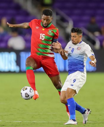 Suriname defender RYAN DONK (15) competes for the ball against Costa Rica forward ARIEL RODRIGUEZ (9) during the 2021 Concacaf Gold Cup Suriname vs Costa Rica soccer match at Exploria Stadium in Orlando, Fl on July 16, 2021.