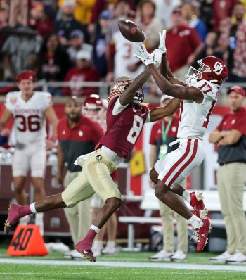 Oklahoma Sooners wide receiver MARVIN MIMS JR. (17) attempts a catch while Florida State Seminoles defensive back RENARDO GREEN (8) defends during the 2022 NCAA Cheez-It Bowl game between the Florida State Seminoles and Oklahoma Sooners at Camping World Stadium  in Orlando, FL on December 29, 2022.