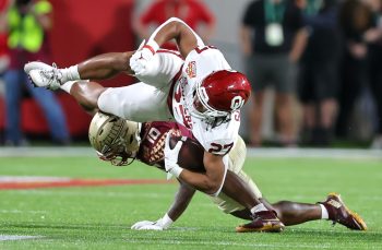 Oklahoma Sooners running back GAVIN SAWCHUK (27) gets tackled during the 2022 NCAA Cheez-It Bowl game between the Florida State Seminoles and Oklahoma Sooners at Camping World Stadium  in Orlando, FL on December 29, 2022.