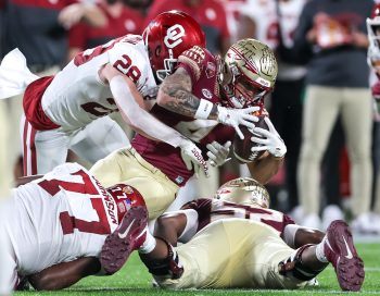 Florida State Seminoles wide receiver MYCAH PITTMAN (4) gets tackled after a reception during the 2022 NCAA Cheez-It Bowl game between the Florida State Seminoles and Oklahoma Sooners at Camping World Stadium  in Orlando, FL on December 29, 2022.