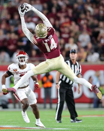 Florida State Seminoles wide receiver JOHNNY WILSON (14) reaches for a catch during the 2022 NCAA Cheez-It Bowl game between the Florida State Seminoles and Oklahoma Sooners at Camping World Stadium  in Orlando, FL on December 29, 2022.