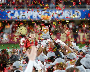 Florida State Seminole players hold the Cheez-It Bowl trophy up high during the 2022 NCAA Cheez-It Bowl game between the Florida State Seminoles and Oklahoma Sooners at Camping World Stadium  in Orlando, FL on December 29, 2022.
