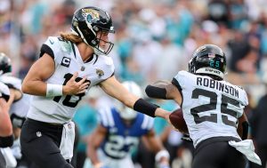 Jacksonville Jaguars quarterback TREVOR LAWRENCE (16) hands off the ball to Jacksonville Jaguars running back JAMES ROBINSON (25) during the Jacksonville Jaquars vs Indianapolis Colts NFL game at TIAA Bank Field Stadium in Jacksonville, Fl on September 18, 2022.