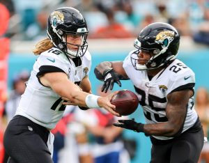 Jacksonville Jaguars quarterback TREVOR LAWRENCE (16) hands off the ball to Jacksonville Jaguars running back JAMES ROBINSON (25) during the Jacksonville Jaquars vs Indianapolis Colts NFL game at TIAA Bank Field Stadium in Jacksonville, Fl on September 18, 2022.