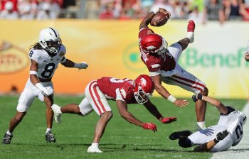 Arkansas Razorbacks quarterback KJ JEFFERSON (1) launches in the air after getting hit during the Outback Bowl at Raymond James Stadium in Tampa, FL on January 1, 2022.