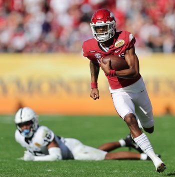 Arkansas Razorbacks quarterback MALIK HORNSBY (4) breaks a tackle from Penn State Nittany Lions safety JI'AYIR BROWN (16) during the Outback Bowl at Raymond James Stadium in Tampa, FL on January 1, 2022.