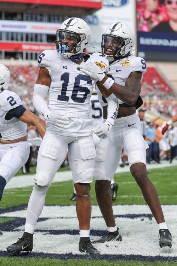 Penn State Nittany Lions safety JI'AYIR BROWN (16) celebrates an interception with Penn State Nittany Lions cornerback JOEY PORTER JR. (9) during the Outback Bowl at Raymond James Stadium in Tampa, FL on January 1, 2022.