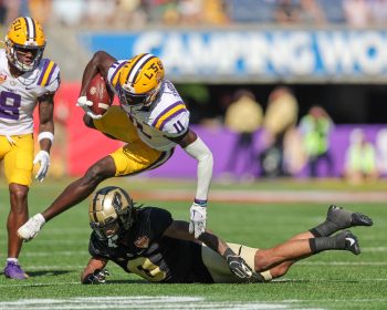 LSU Tigers wide receiver BRIAN THOMAS JR. (11) leaps over a defender during the 2023 NCAA Cheez-It Citrus Bowl game between the LSU Fighting Tigers and the Purdue Boilermakers at Camping World Stadium in Orlando, FL on January 2, 2023.