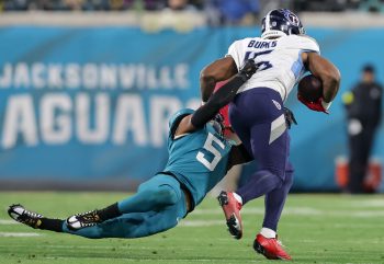 Tennessee Titans wide receiver TREYLON BURKS (16) gets tackled by Jacksonville Jaguars safety ANDRE CISCO (5) during the Jacksonville Jaguars vs Tennessee Titans NFL game at TIAA Bank Field Stadium in Jacksonville, Fl on January 7, 2023.