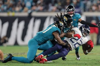 Tennessee Titans running back DERRICK HENRY (22) gets tackled during the Jacksonville Jaguars vs Tennessee Titans NFL game at TIAA Bank Field Stadium in Jacksonville, Fl on January 7, 2023.