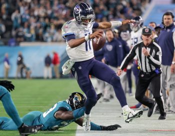 Tennessee Titans quarterback JOSHUA DOBBS (11) gets pushed out of bounds during the Jacksonville Jaguars vs Tennessee Titans NFL game at TIAA Bank Field Stadium in Jacksonville, Fl on January 7, 2023.