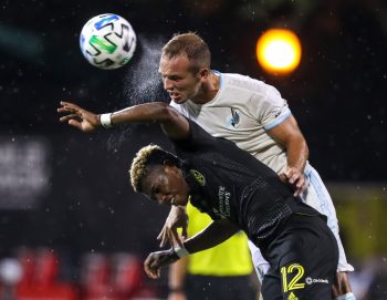 Columbus Crew midfielder LUIS DIAZ (12) goes up for a header against Minnesota United defender CHASE GASPER (77) during the MLS is Back Tournament Columbus Crew SC vs Minnesota United FC match at ESPN Wide World of Sports Complex in Orlando, Fl on July 28, 2020.