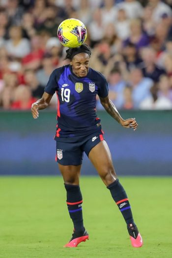 United States defender CRYSTAL DUNN (19) gets a header during the SheBelieves Cup United States vs England match at Exploria Stadium in Orlando, Fl on March 5, 2020.
