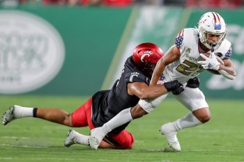 Tampa, FL - November 12: South Florida Bulls running back Brian Battie (21)gets tackled by Cincinnati Bearcats linebacker Darrian Beavers (0) during a college football game between South Florida Bulls and Cincinnati Bearcats played on November 12, 2021 at Raymond James Stadium in Tampa, FL. (Photo credit: Cory Knowlton/Sportscene Media)