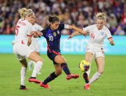 United States forward CARLI LLOYD (10) competes for the ball against England defender STEPH HOUGHTON (5) and England defender LEAH WILLIAMSON (14) during the SheBelieves Cup United States vs England match at Exploria Stadium in Orlando, Fl on March 5, 2020.
