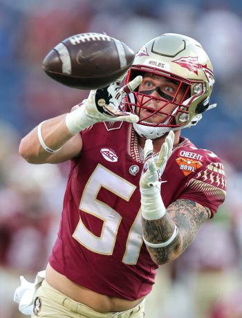 Florida State Seminoles linebacker CHASE OLIVER (51) make a catch at warm ups during the 2022 NCAA Cheez-It Bowl game between the Florida State Seminoles and Oklahoma Sooners at Camping World Stadium  in Orlando, FL on December 29, 2022.