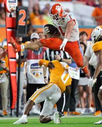 Clemson Tigers running back WILL SHIPLEY (1) leaps over  Tennessee Volunteers defensive back DONEIKO SLAUGHTER (0) during the 2022 NCAA Capital One Orange  Bowl game between the Tennessee Volunteers  and the Clemson Tigers at Hard Rock Stadium  in Miami Gardens, FL on December 30, 2022.