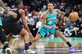 Mar 9, 2024; Charlotte, North Carolina, USA;  Charlotte Hornets guard Nick Smith Jr. (8) drives the play against Brooklyn Nets guard Dennis Smith Jr. (4) during the third quarter at Spectrum Center. Mandatory Credit: Cory Knowlton-USA TODAY Sports